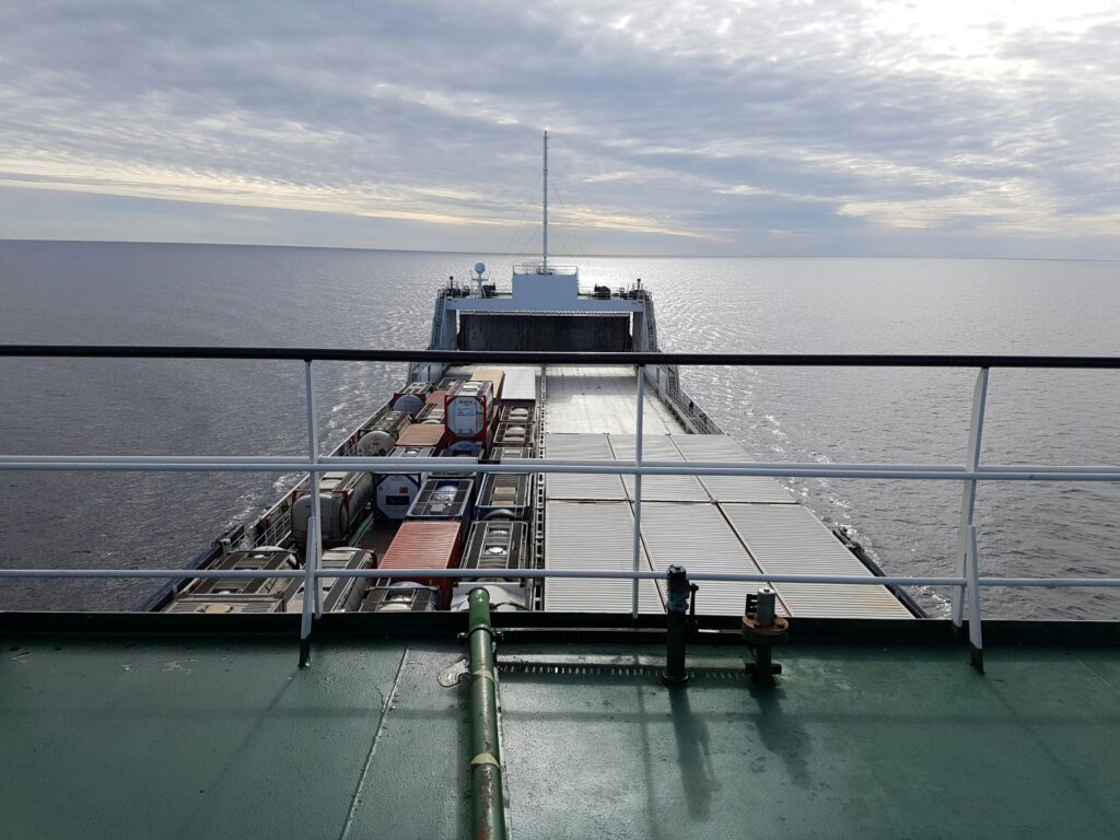 Sea cargo freight being transported by sea shipping from one territory to another on a large ship.