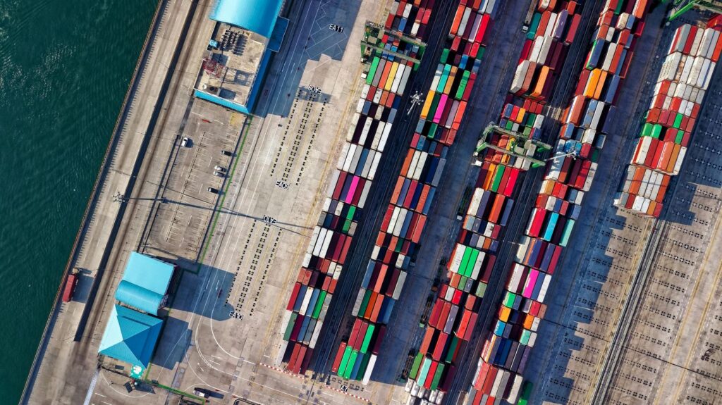 Colourful seafreight containers waiting in a shipyard to be transported by sea.
