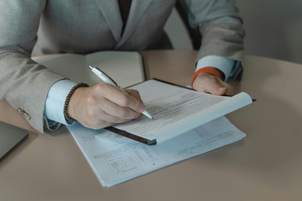 Close of import broker sydney reviewing documents with a pen and clipboard at a customers brokerage office