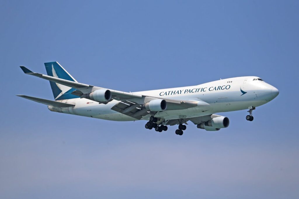 Air freight services with Cathay Pacific Cargo plane in transit - supporting freight forwarding US to Australia and freight shipping overseas.