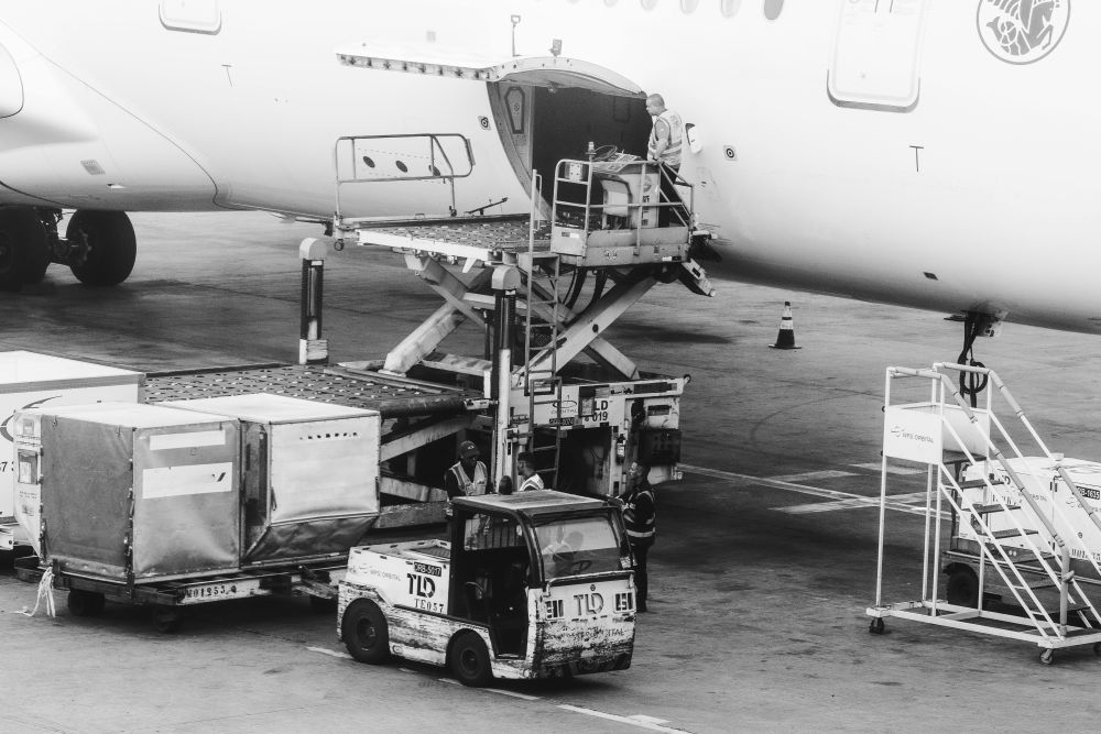 Air freight transportation: Pallets being loaded in to the cargo hold of a large aircraft