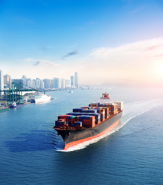 Cargo ship sailing into port providing global logistics services