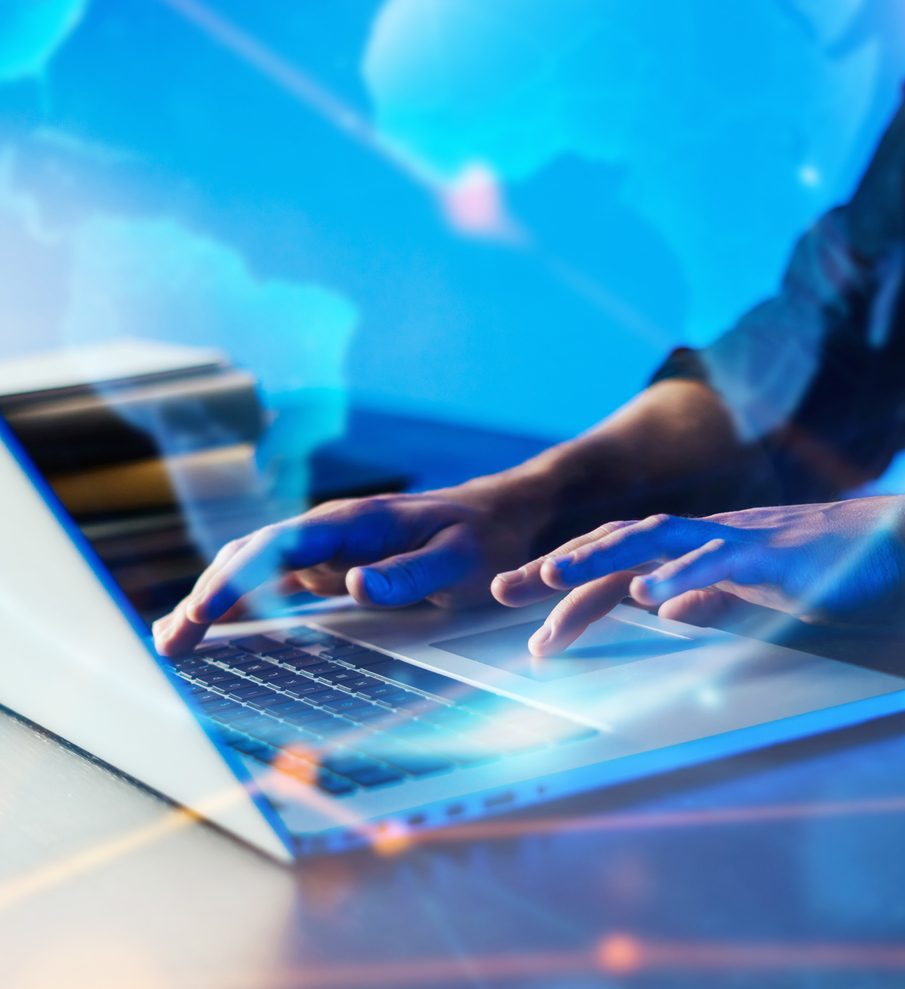 Close up of hands typing on a keyboard.